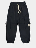 Black cargo pants with multiple pockets on a light gray background