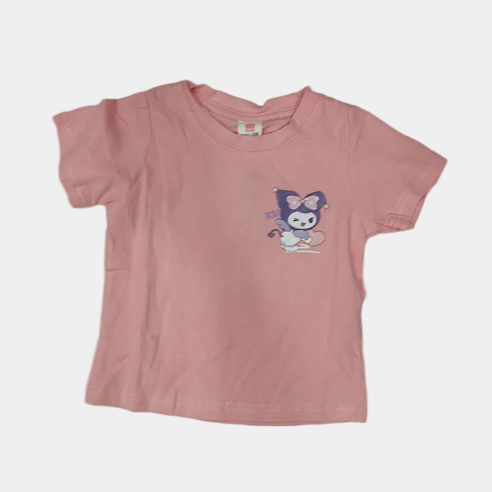 Pink t-shirt with cartoon character on a light gray surface