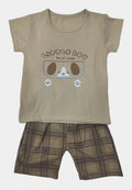 Beige t-shirt with cartoon design and plaid shorts on a light gray background