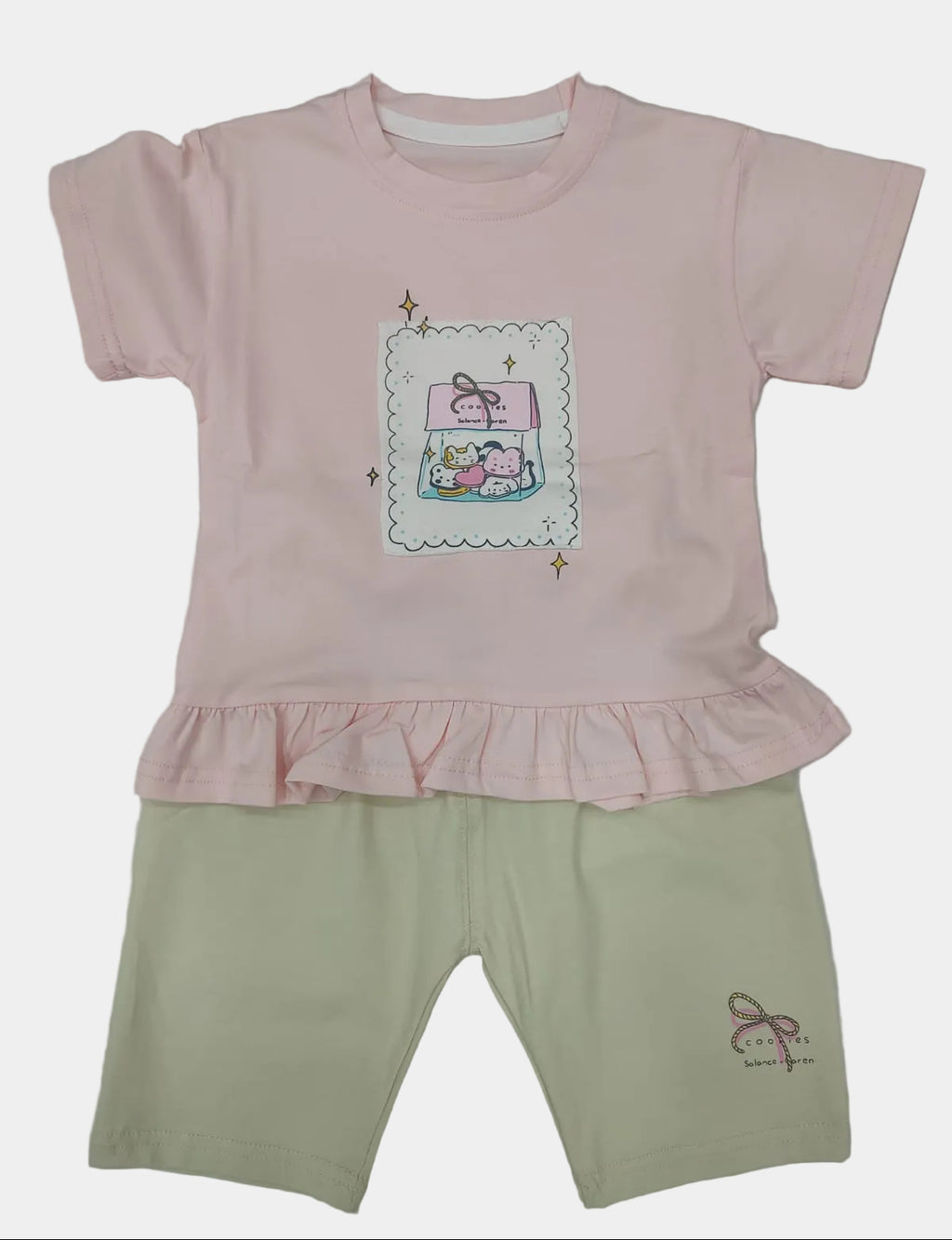 Pink shirt with a cartoon design and beige pants on a white background