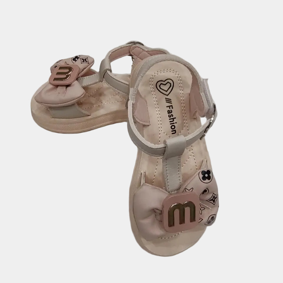 Pair of pink children's sandals on a white background