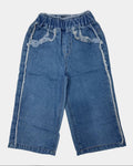 Pair of blue jeans with lace trim on a white background