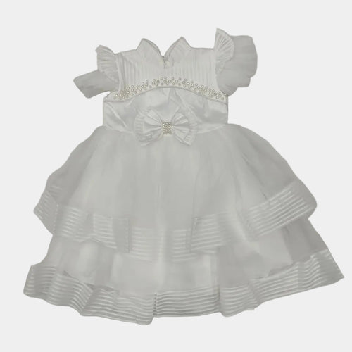 White dress with a bow on a light gray background