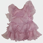 Pink dress with ruffled layers on a white surface
