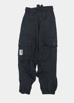 Black pants with a brand logo on a light gray background