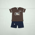 Brown sleeveless shirt with cartoon design and gray shorts on a white background