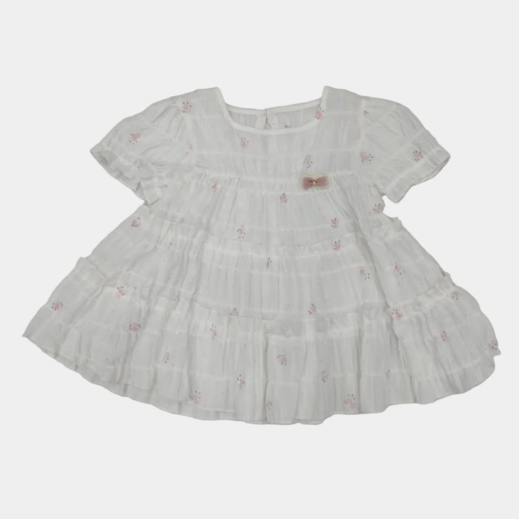 White dress with floral embroidery on a white background