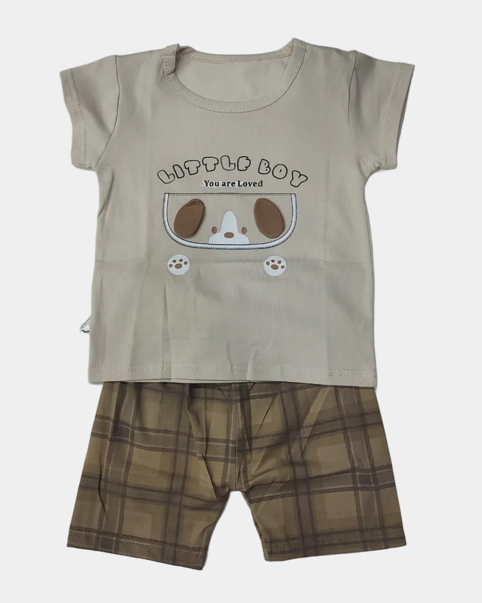 Children's beige t-shirt with cartoon design and plaid shorts on a light gray background