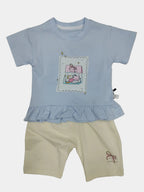 Children's light blue top and beige shorts set on a plain background