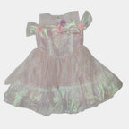 Pink sequined dress with a bow on a white background