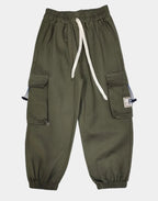 Green pants with white drawstring on a light gray background