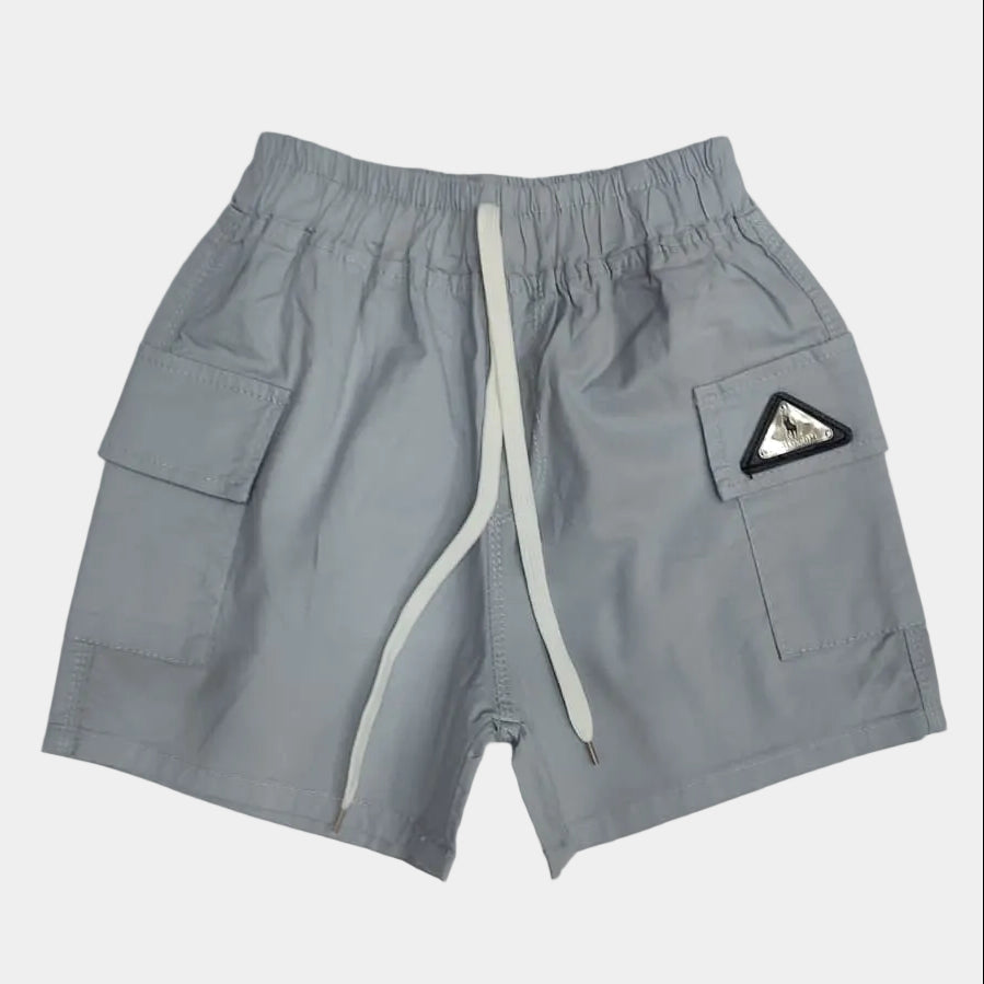 Gray shorts with a logo patch on a light gray background