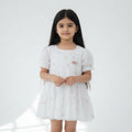 White dress with floral embroidery on a white background