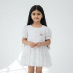 White dress with floral embroidery on a white background