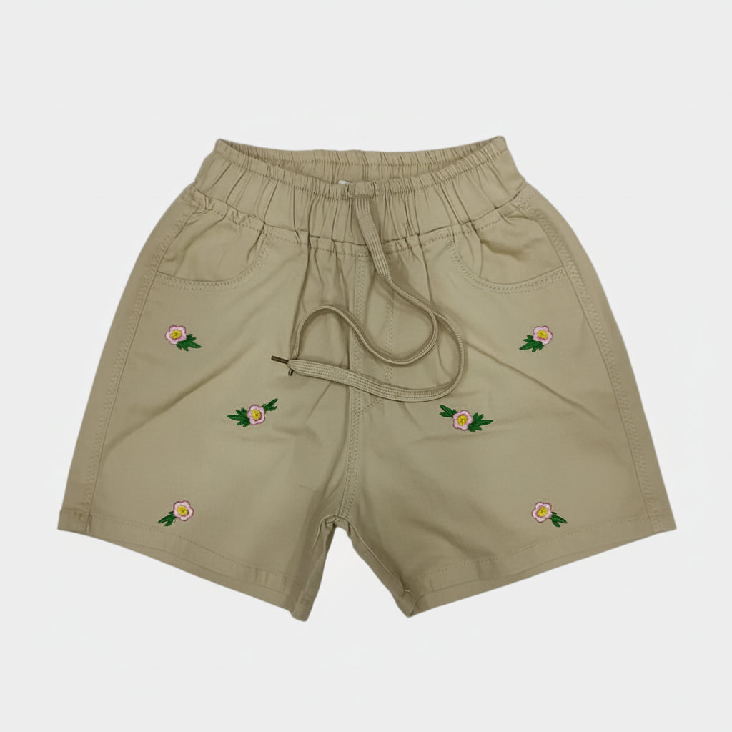 Beige shorts with floral embroidery on a white background