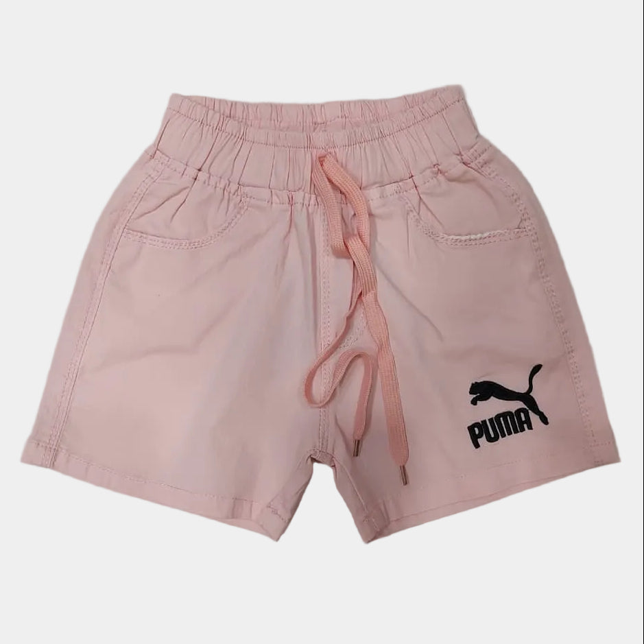 Pink shorts with Puma logo on a light gray background