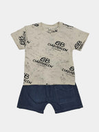 Beige t-shirt with black branding and blue shorts on a gray background
