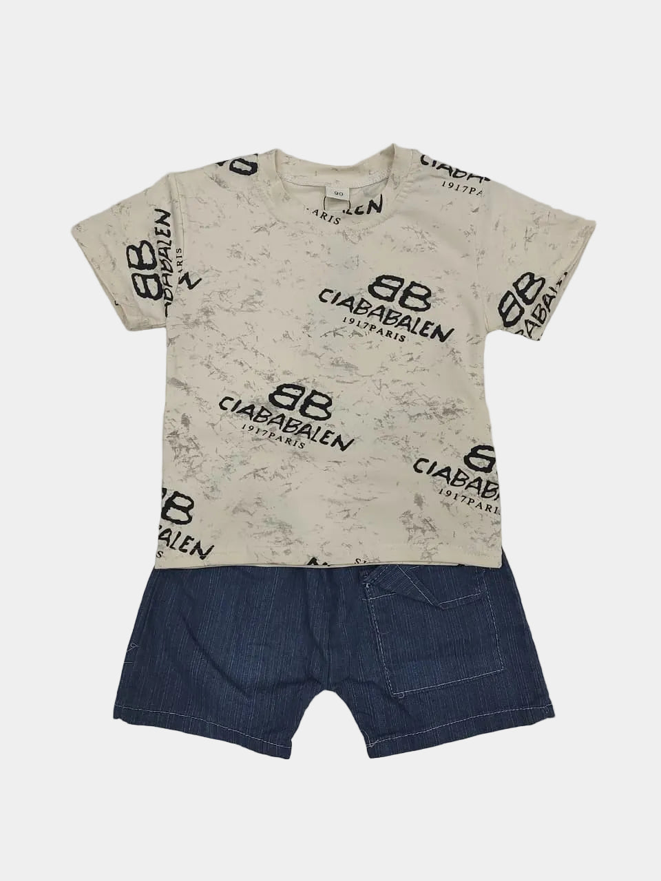 Beige t-shirt with black branding and blue shorts on a gray background