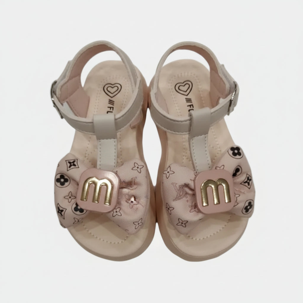 Pair of children's sandals with decorative bows on a light gray background