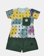 Children's outfit with a colorful shirt featuring numbers and green shorts on a white background