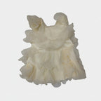Light yellow dress with ruffled layers on a white surface