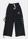 Black cargo pants with buttons and drawstring on a light gray background