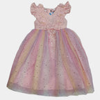 Colorful children's dress on a white sheet with a tiled floor background