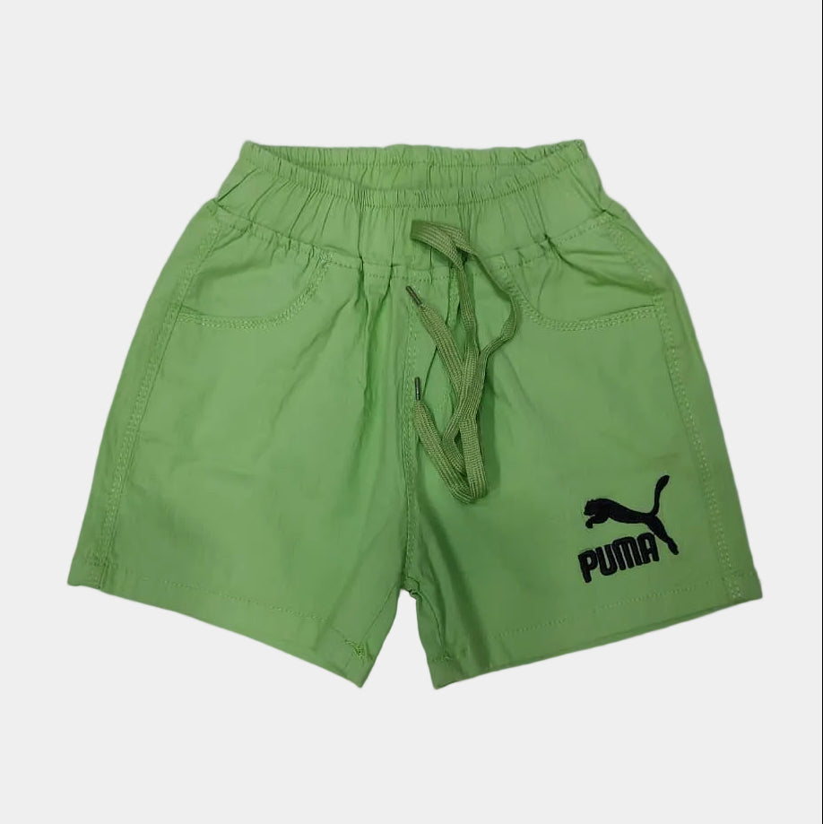 Green shorts with a brand logo on a light gray floor