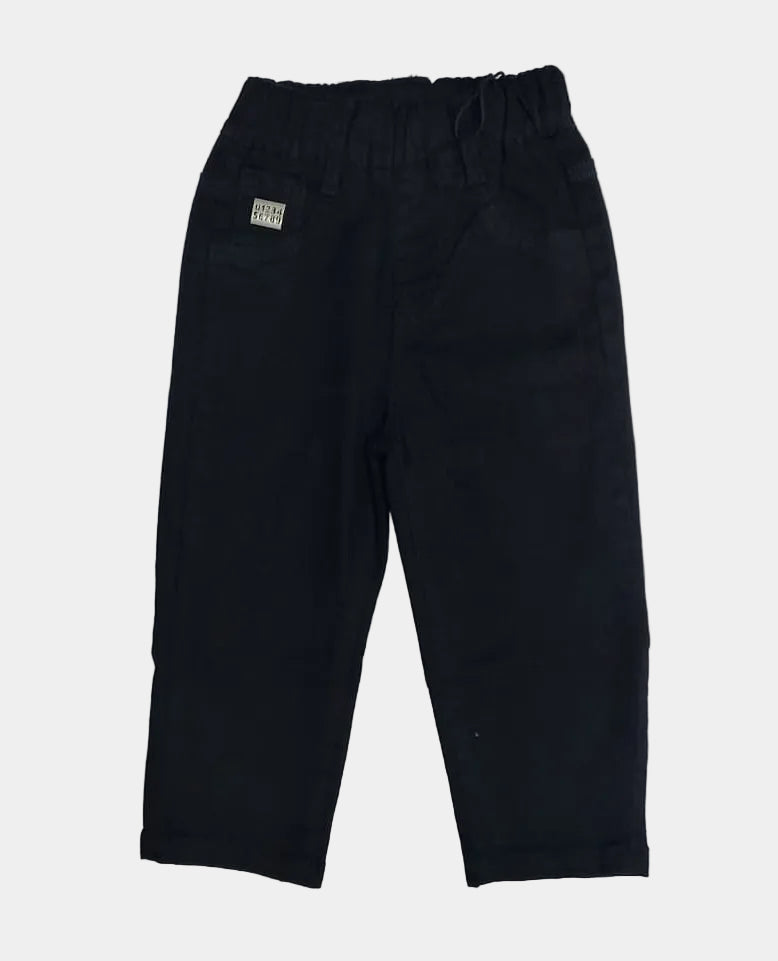 Black pants on a white surface with beige pants partially visible