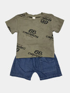 Children's outfit with green t-shirt and blue shorts on a light gray background