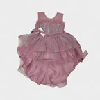 Pink dress with a sheer overlay on a light gray background