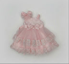 Pink floral baby outfit with a bow on a white background