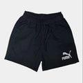 Black Puma shorts on a light gray background