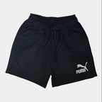 Black Puma shorts on a light gray background