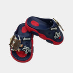 Navy and red sandals with decorative elements on a light gray background