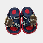 Pair of children's sandals with decorative elements on a light gray background