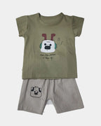 Children's outfit with green t-shirt and beige shorts on a white background