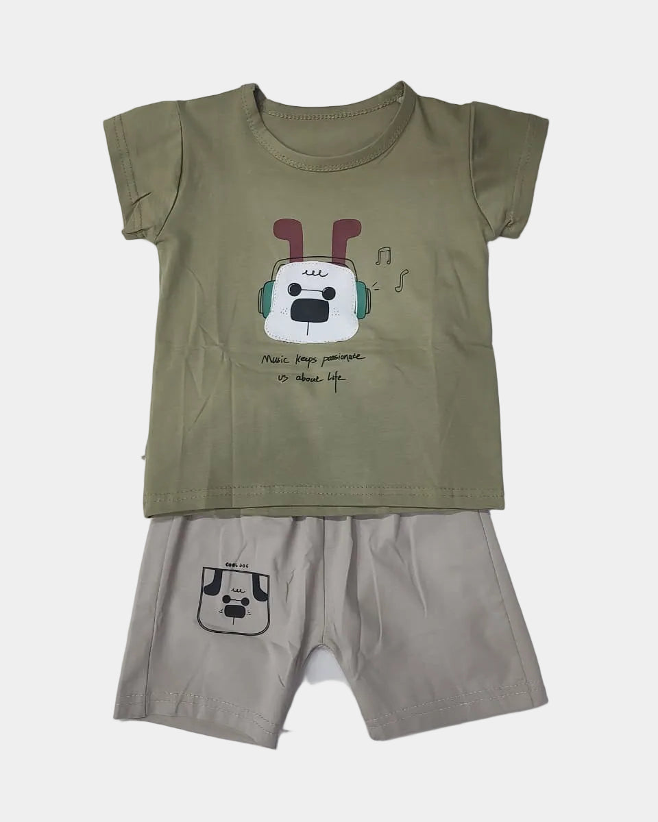 Children's outfit with green t-shirt and beige shorts on a white background