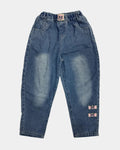 Pair of blue jeans with visible distressing on a light gray background