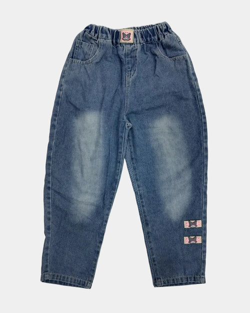 Pair of blue jeans with visible distressing on a light gray background