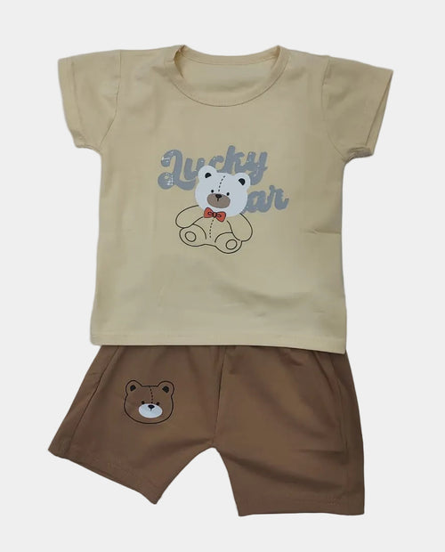 Children's outfit with beige t-shirt and brown shorts featuring bear graphics on a gray background