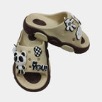 Pair of children's sandals with cartoon character design on a white background