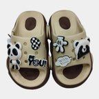 Beige sandals with decorative charms on a white background