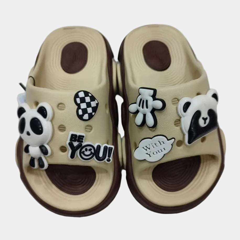 Beige sandals with decorative charms on a white background