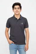 Dark gray polo shirt with a logo on a light gray background