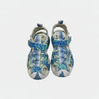 Pair of blue and gray sandals with a pattern on a white background