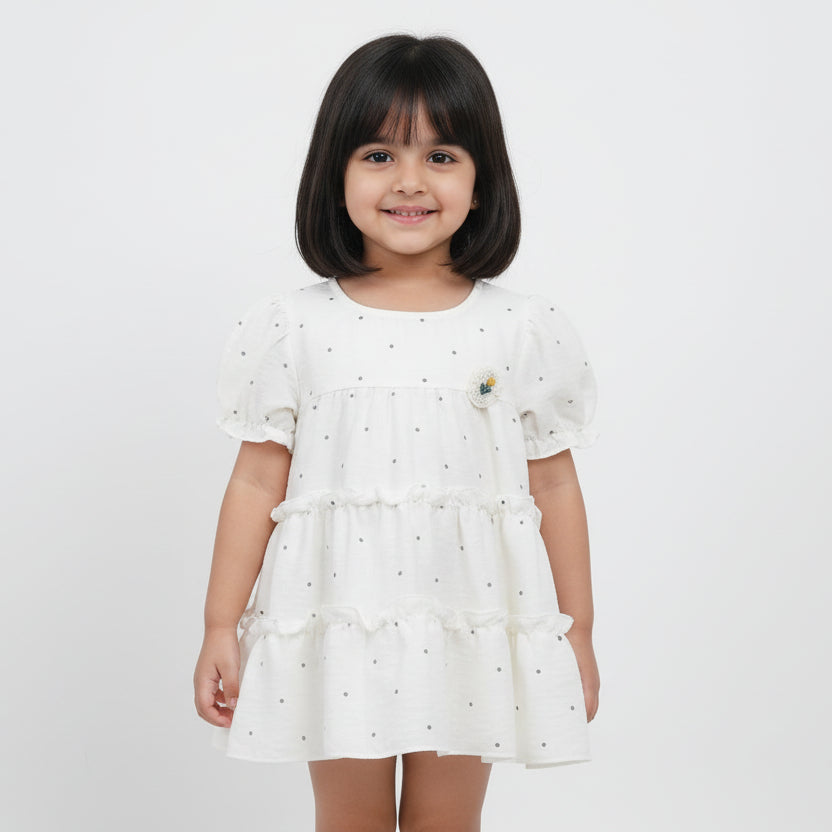 White dress with black polka dots on a light gray background